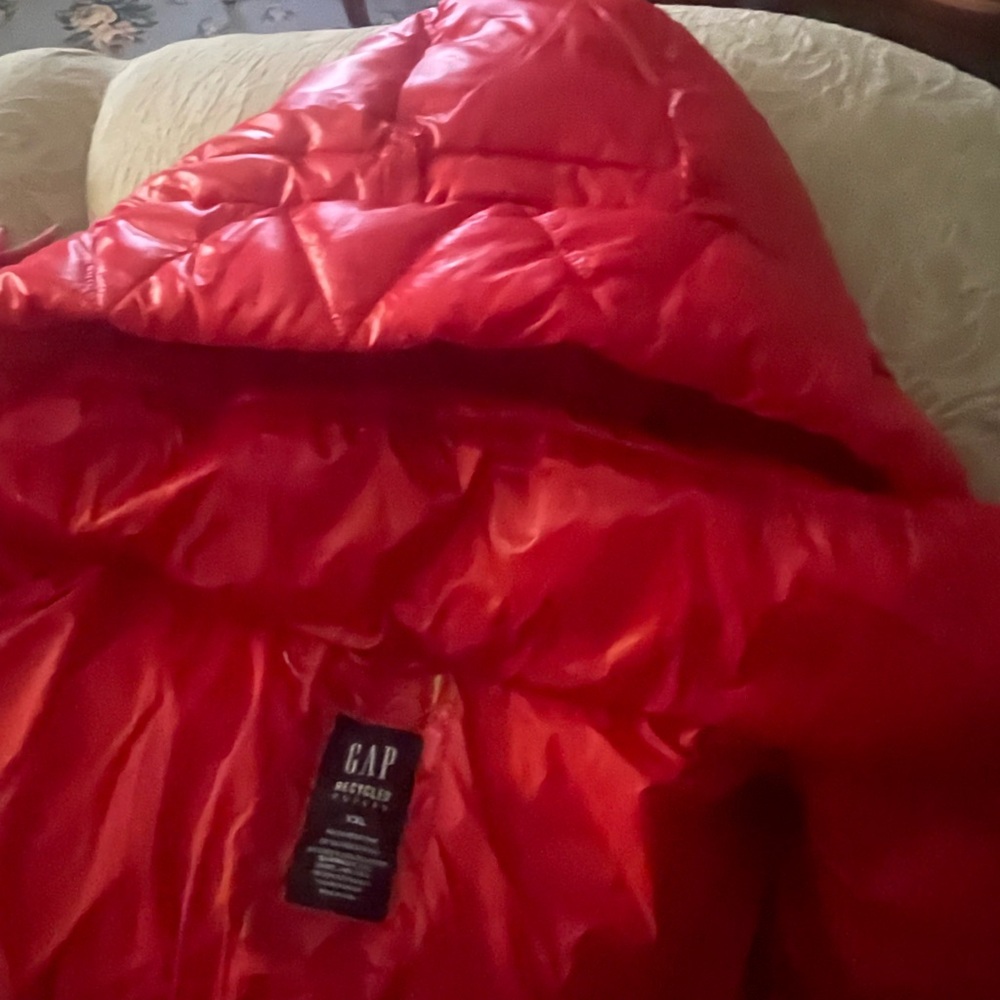 A gorgeous red puffer hooded jacket in an xl/xxl. Brand new but no tags!